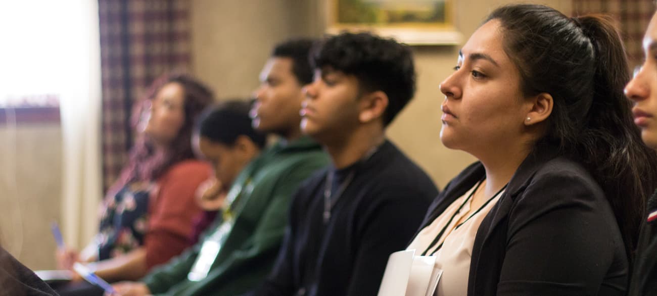 Latinx Leads delegates seated in a packed conference session