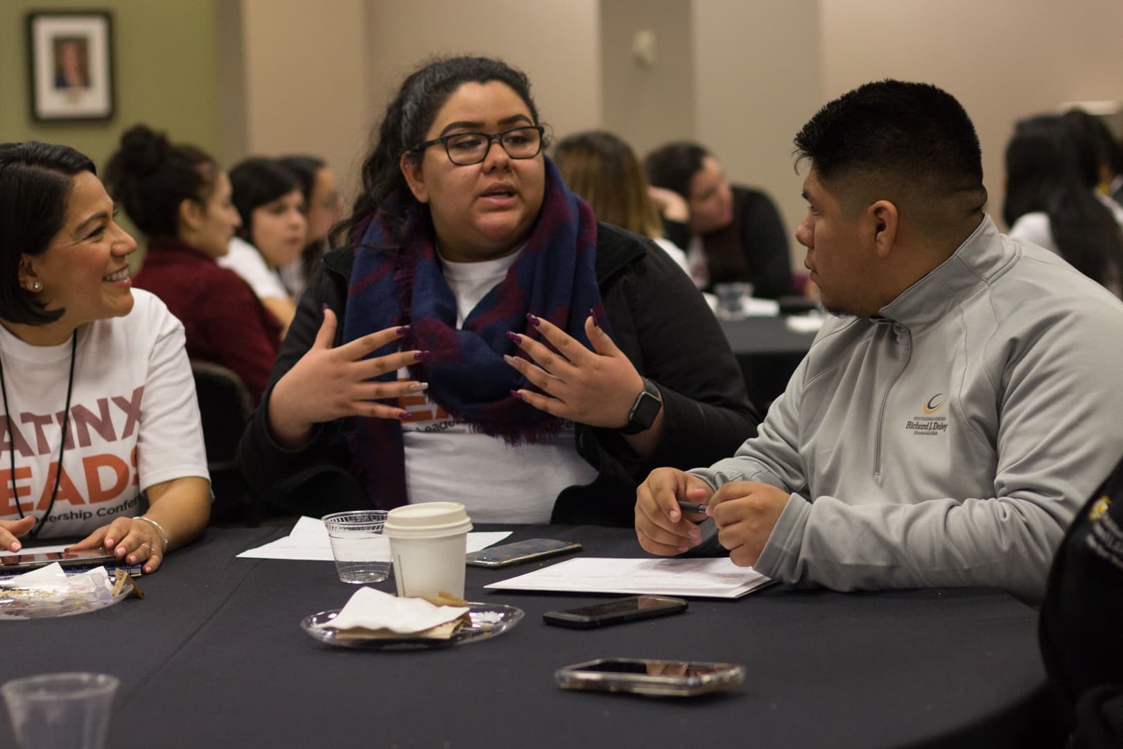 Delegates in candid conversation at a conference table